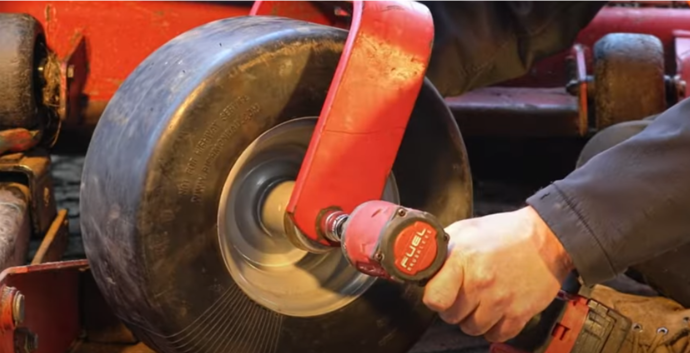 Securing the axle hardware on a newly fitted zero turn mower front wheel